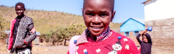 A girl smiles in a Christmas jumper