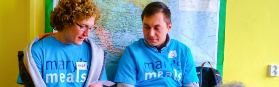 Two volunteers in discussion at a Mary's Meals event