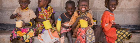 Children in Turkana, Kenya all sit together to eat at school