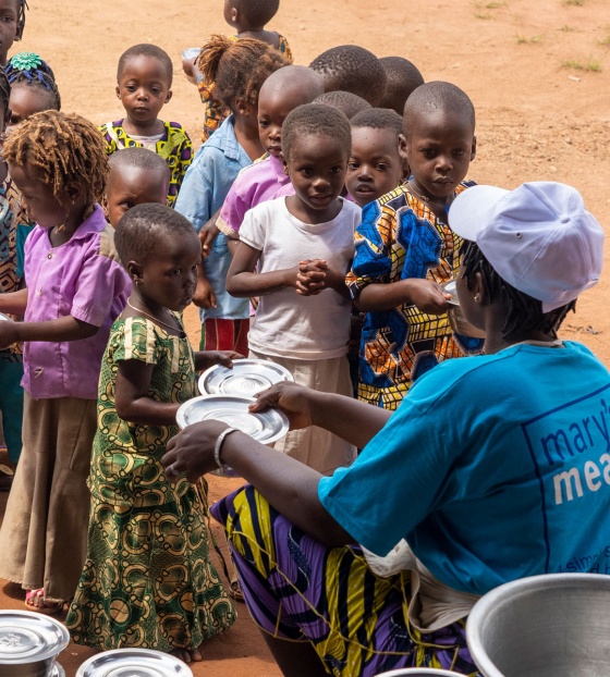 Children being served food in Benin
