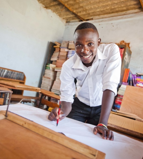 A child from Zambia enjoying drawing while at school. 