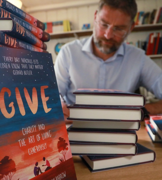 Magnus MacFarlane-Barrow, founder of Mary's Meals signing copies of his book, GIVE. 