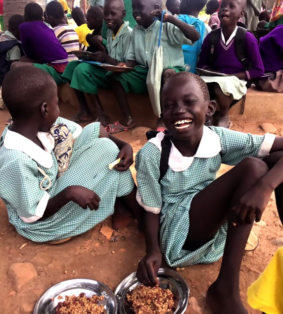 A girl laughs with her friends in South Sudan