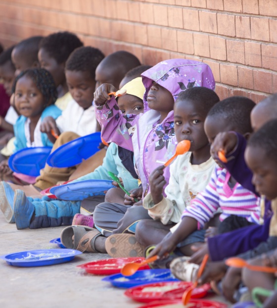 Children eating Mary's Meals at their school in Malawi