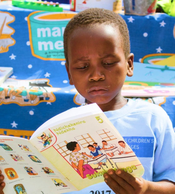 A young boy reads a book