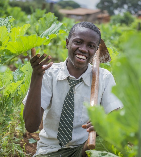 a young boy planting crops