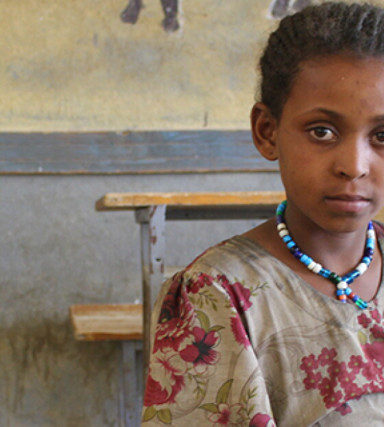 Picture of Mahlet sitting in a classroom looking into the camera.