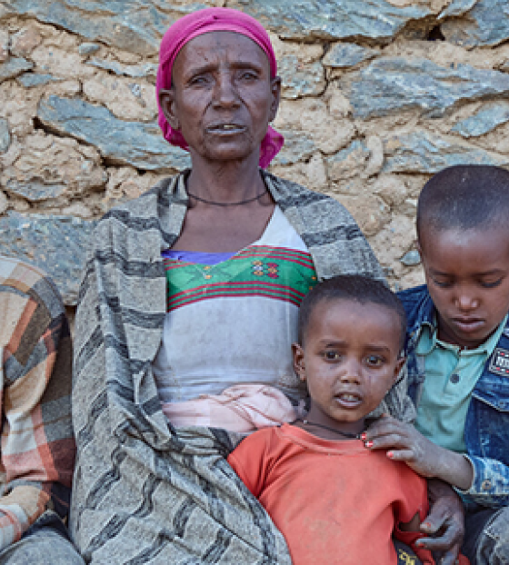  Letemariam and her family sitting looking directly into the camera.