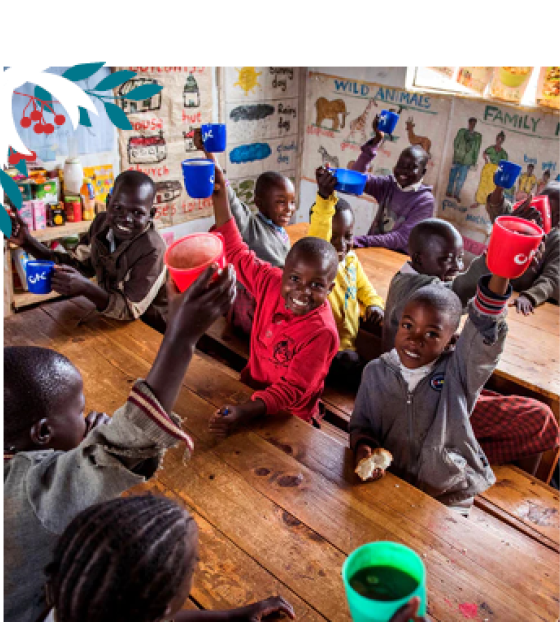 Children holding mugs up in the classroom