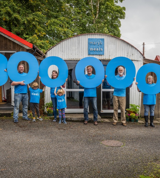 2025 - 3 Million sign held by Magnus and Staff