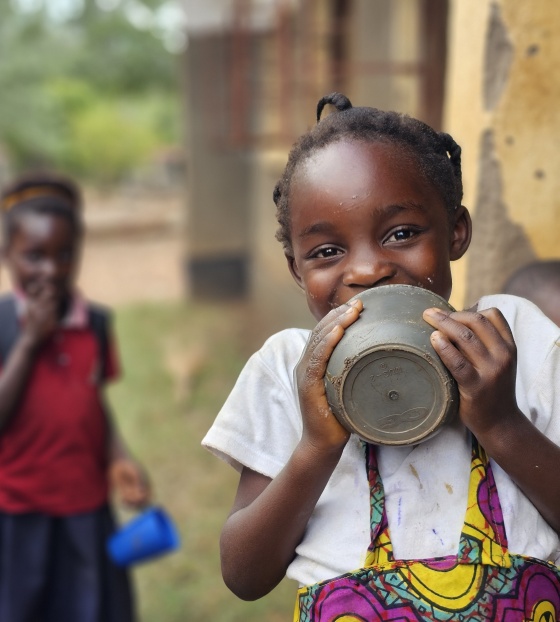 A happy girl in Zambia after finishing her Mary´s Meals porridge at school