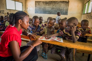 children in class listening attentively to their teacher