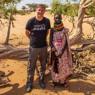 two people standing side-by-side posing for a photo