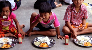 Children sit to eat in Thailand