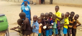young children lining up to wash their hands