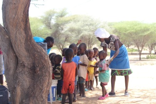 Children in Kenya waiting to wash their hands before being served Mary's Meals.