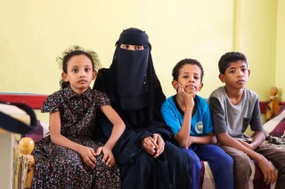 Amani Yasser from Yemen with her three children who now receive Mary's Meals every school day.