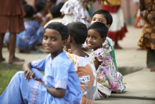 A group of friends sit and talk together