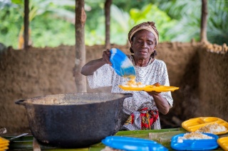 Woman plating up school meals for children.