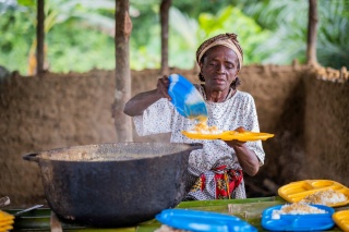 Woman plating up school meals for children.