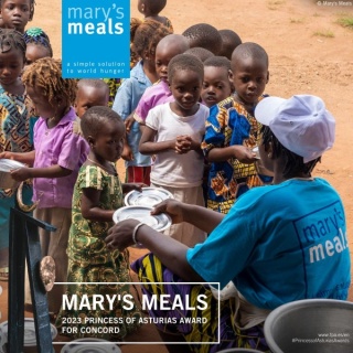 Image showing children being fed with the details of Mary's Meals award. 