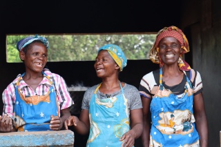 Volunteer cooks smiling and laughing. 