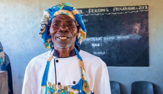 A volunteer cook in Zambia smiles