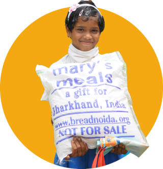 A girl in India with food from Mary's Meals