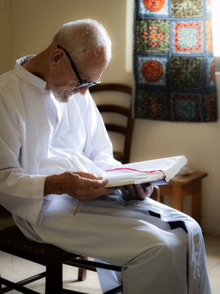 Image of Father Garry Jenkins reading.